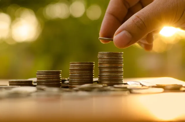 A person stacking coins