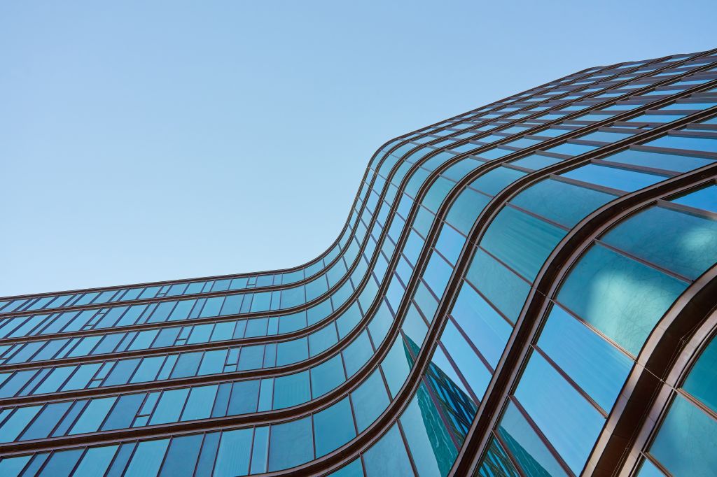 Abstract view of a building with a curved wall of glass windows
